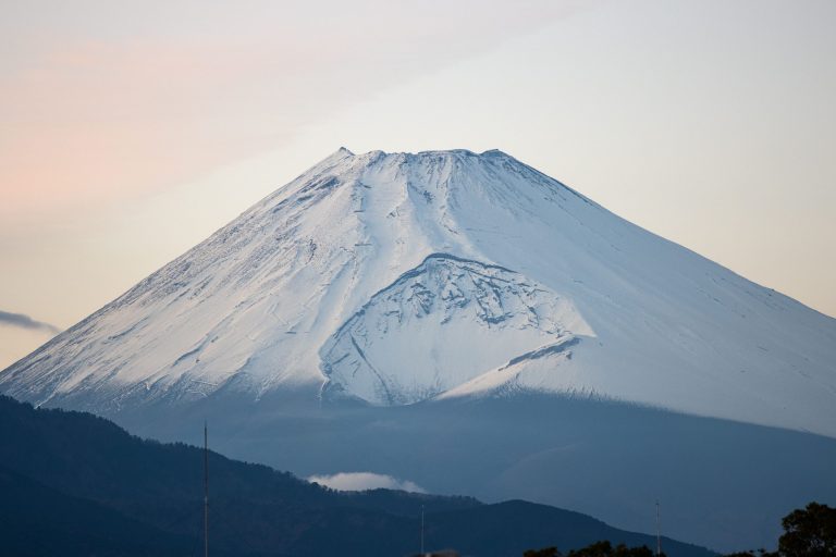冬季覆雪的富士山，山梨縣擬對沒報備就爬富士山的登山客，收取直升機救援費用
